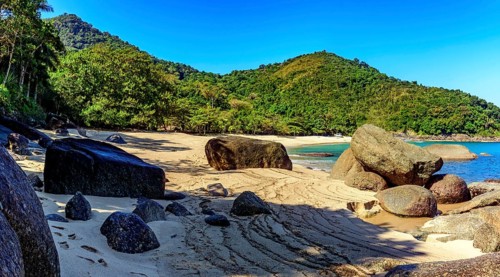 Forest, hill, rocks and sea of stunning Indaiauba beach in Ilhabela island coast os Sao Paulo,