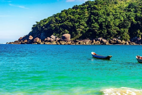 Rustic wooden fishing canoes on the sea waters of Ilhabela Island on the northern coast of Sao
