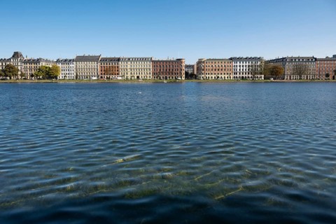 Historic buildings on the waterfront under a blue sky, Søerne, Sortedams Sø, Copenhagen Lakes,