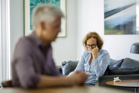 Symbolic photo on the subject of problems in a partnership. An older woman and an older man sitting