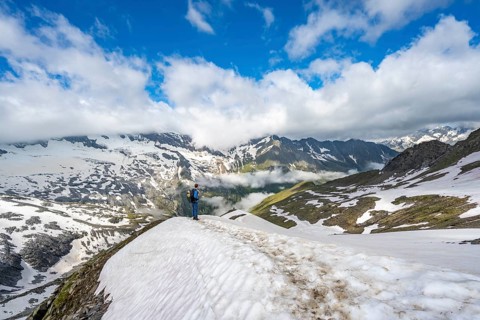 Mountaineer on hiking trail with snow, mountain landscape with summit Hoher Weißzint and