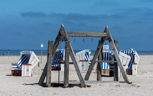 Beach chairs and signs on the sandy beach of the North Sea, Sankt Peter-Ording, Schleswig-Holstein,