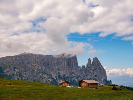 Alpine huts in front of the Sciliar, Punta Santner, Dolomites, Alpe di Siusi, South Tyrol, Italy,