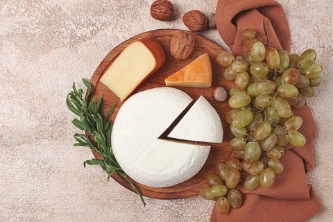 Georgian cheese, Imeretian and smoked suluguni, grapes, nuts, on a cutting board, Georgian cuisine,