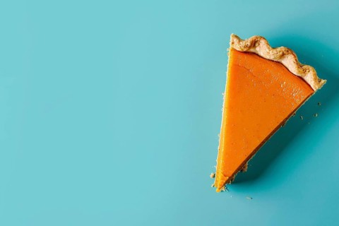 Top vie of single slice of pumpkin pie on blue background with copy space. Generative Ai, AI