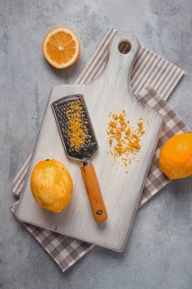 Grated lemon zest, on a cutting board, with a grater, top view, no people