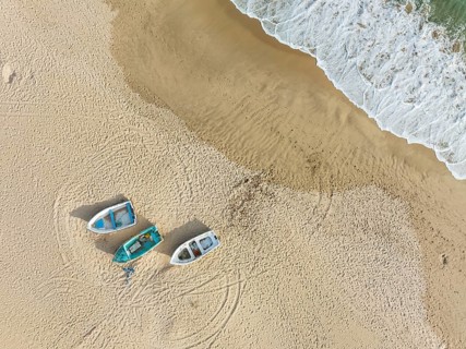 Boats at the shore of the Atlantic Ocean near Bolonia. Aerial view. Drone shot. Cádiz province,