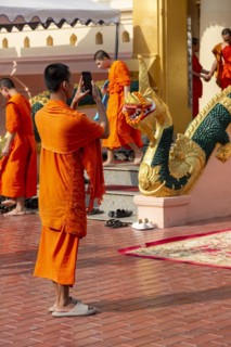 Monk in front of a Buddha statue, Bhumispara-mudra, Buddha Gautama at the moment of enlightenment,
