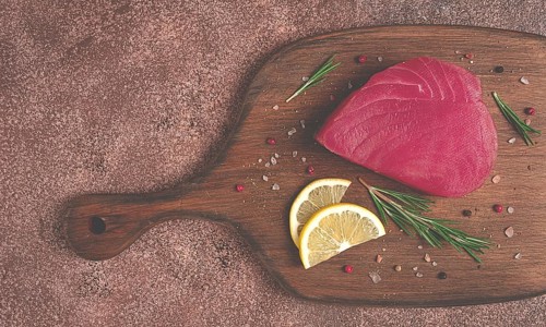 Fresh red tuna fillet, for steak, raw, top view, on a cutting board, no people