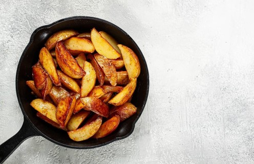 Fried potato slices, in a cast-iron pan, homemade, no people