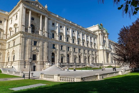 The Hofburg Imperial Palace Palace in Vienna, impressive architecture with green space and clear