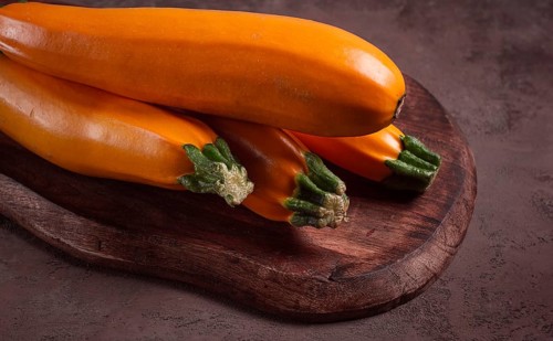 Yellow zucchini, fresh, raw, on a wooden chopping board, no people
