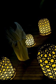 Woman with Bathrobe Standing Cloe to Illuminated Lamps at Night