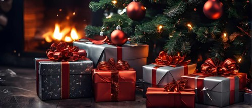 Beautiful wrapped Christmas gifts with shiny ribbons and bows stacked under a evergreen tree in a