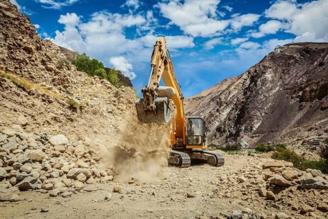Excavator doing road construction repair in Himalayas. Ladakh, Jammu and Kashmir, India, Asia