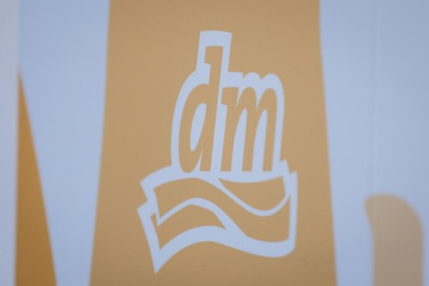 The logo of the drugstore chain DM is stuck on a window front in Berlin, 27/03/2024