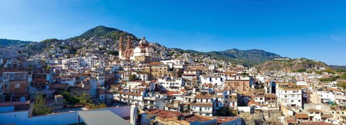 Mexico, Scenic panoramic view of Taxco historic center with colonial houses on the hills and famous