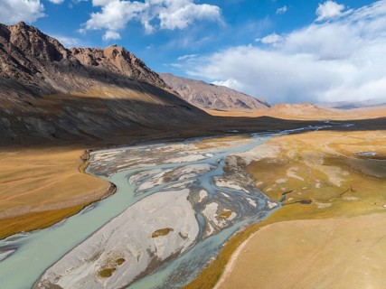Aerial view, Burkhan mountain valley with meandering river, barren dramatic mountain landscape,