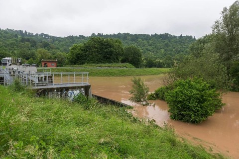 Symbolic image extreme weather, global warming, climate change, barrier, flood retention basin,