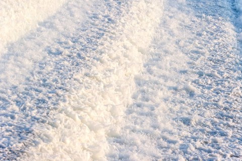 Agitated white foaming water, spray on cascades at the Lech weir, river Lech, background, Landsberg