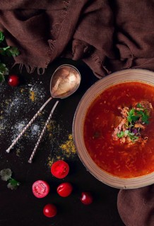 Traditional Georgian dish spicy tomato, Kharcho soup, on a dark background, no people, top view