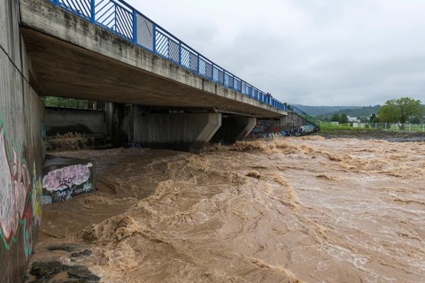 Symbolic image extreme weather, global warming, climate change, barrier, flood protection, bridge,