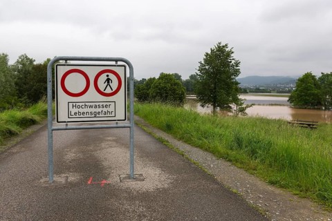 Symbolic image extreme weather, global warming, climate change, information board, flood retention