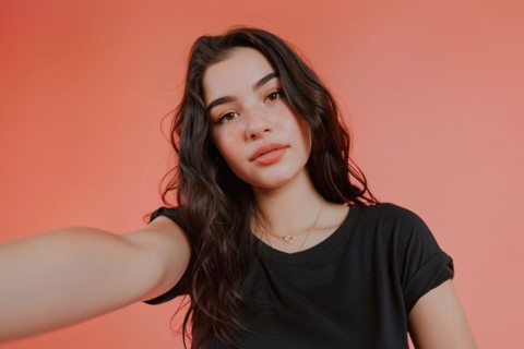 Young teenage girl taking selfie in front of pink studio background. KI generiert, generiert, AI