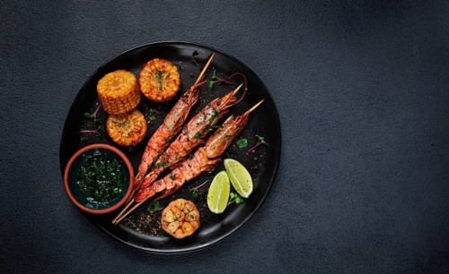 Langoustines on skewers, shrimp kebab, with fried corn, spices and herbs, homemade, no people