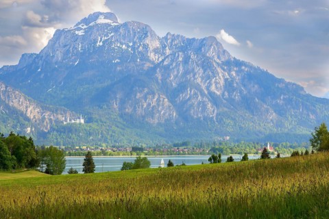 Lake Forggensee in front of the fairytale castles Schwanstein Castle and Hohenschwangau Castle in