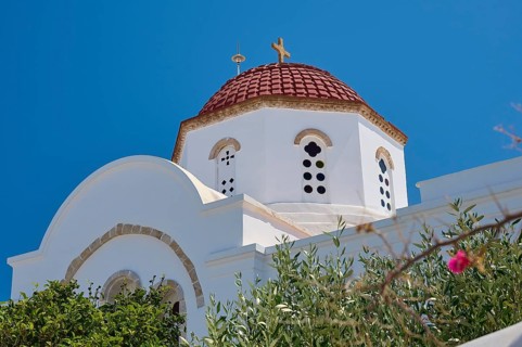 Detailed view of a church with red dome and white walls, surrounded by vegetation, Chora, Old Town,