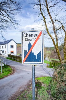 Town sign Cheneux Stoumont next to the bunker of Cheneux, view of the street and the famous house