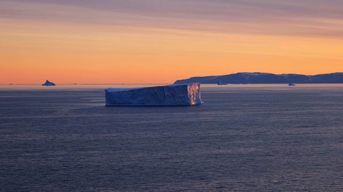 Iceberg seen from cruise ship vacation near Greenland coast in Arctic circle near Ilulissat Disko