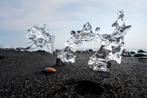 Ice, piece of ice on black sand beach, on black lava beach Diamond Beach, Southeast Iceland,