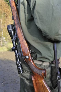 Hunter with shotgun and scope in the Ardennes, Belgium, Europe