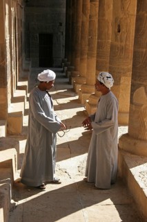 Two Egyptian men carrying jalabiyas at the Philae Temple of Isis on Agilkia Island in Lake Nasser,