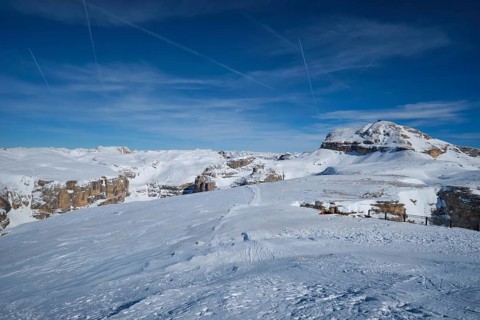 View of a ski resort piste and Dolomites mountains in Italy from Passo Pordoi pass. Arabba, Italy,