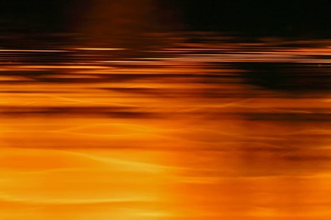 The sun's play of light in the water at sunset on the Trebel River, Peene Valley River Landscape