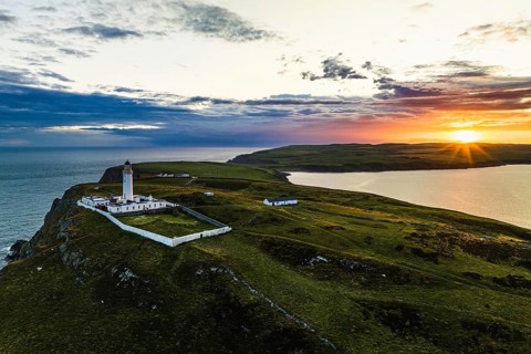 Sunset over Mull of Galloway Lighthouse from a drone, Mainland Scotland, Scotland, UK