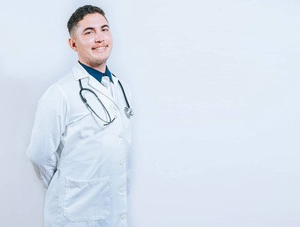 Portrait of smiling young doctor isolated. Portrait of latin doctor isolated with copy space