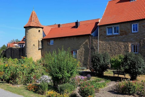 Part of the old town wall and in front of it the moat gardens, Mainbernheim, Lower Franconia,