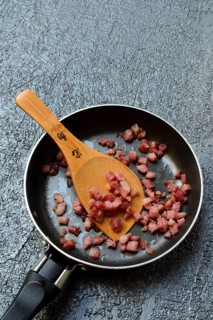 Fried bacon cubes in pan, bacon