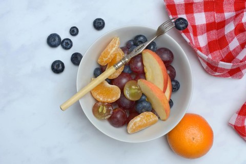 Various pieces of fruit in bowl, fruit salad