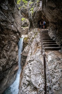 Hiker in a gorge, Hammersbach flows through Höllentalklamm, near Garmisch-Partenkirchen,