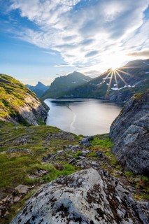 Mountain landscape with lake Tennesvatnet, at sunrise with sun star, Moskenesøya, Lofoten,