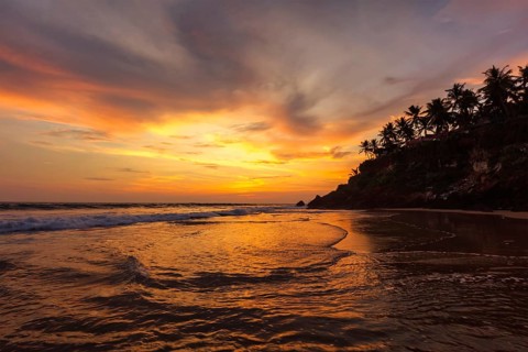 Sunset on Varkala beach popular tourist destination in Kerala state, South India