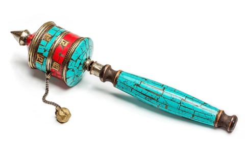 Tibetan buddhist Mani wheel or hand prayer wheel isolated on white