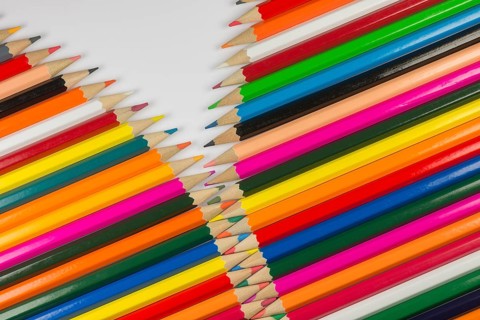 Abstract composition of a set cedar wooden colour pencils against a white background in zipper