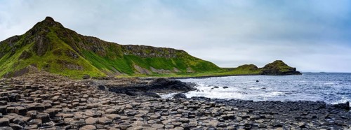 A panorama landscape view of the many volcanic basalt columns of the Giant's Causeway in Northern