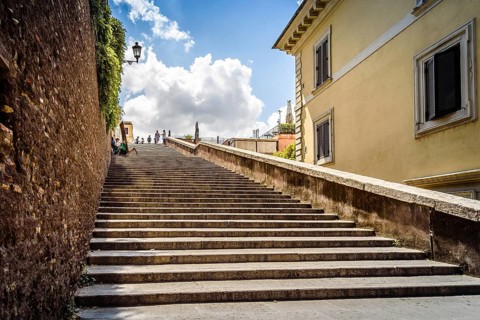 Rome, Italy, August 18, 2016: Lateral staircase to Piazza della Trinita dei Monti with artist
